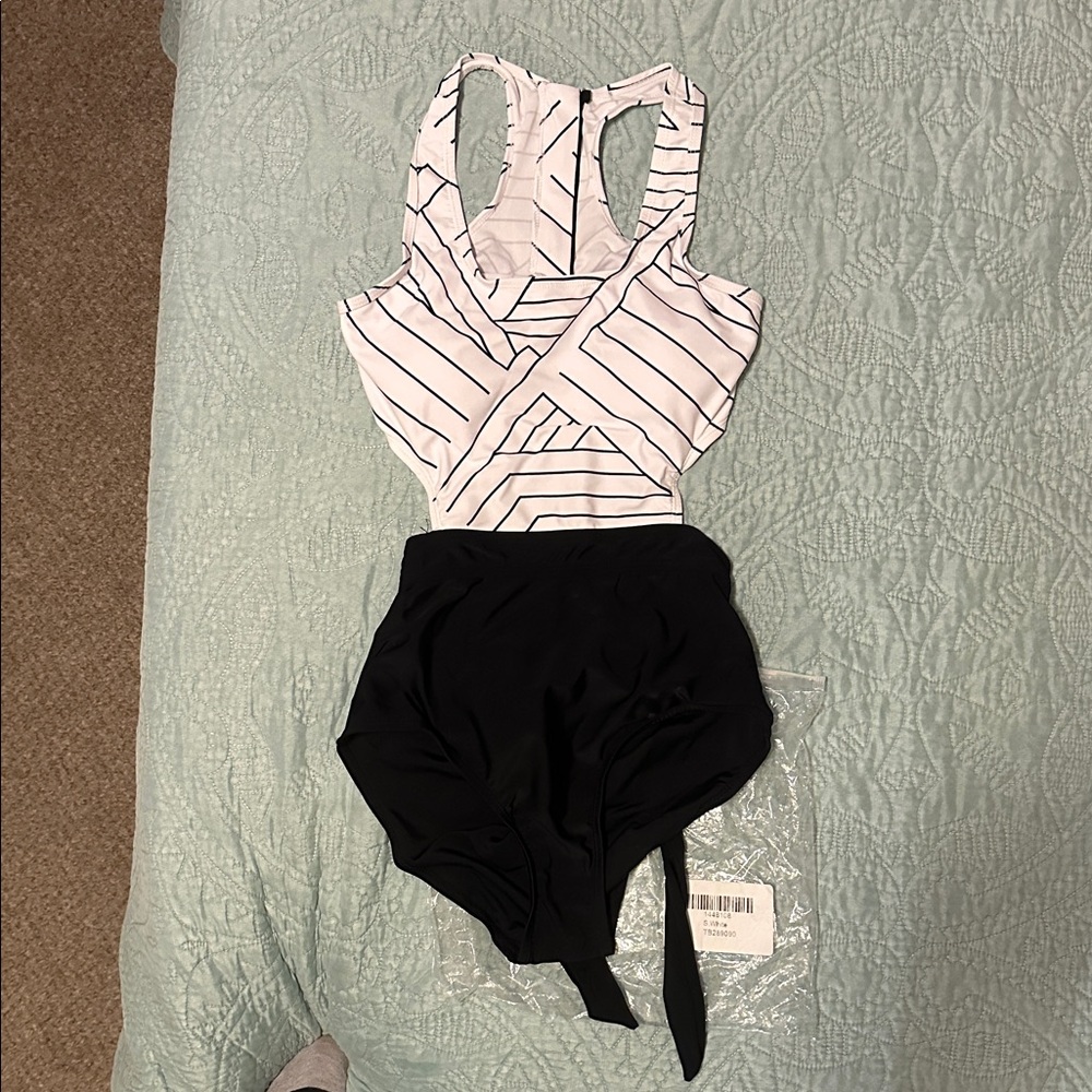 NWOT Striped Black and White Swimsuit. Side cutouts with bow in back.